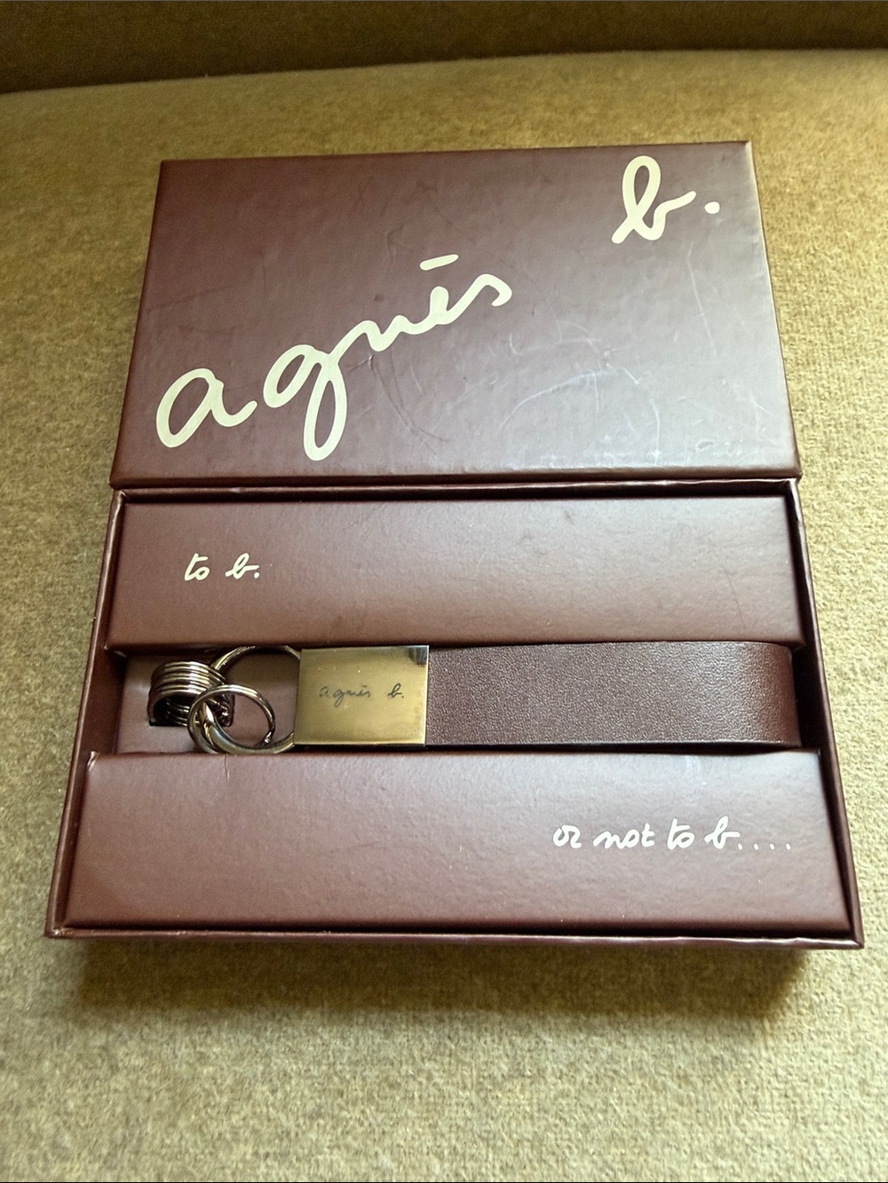 New in box Agnes B leather keychain